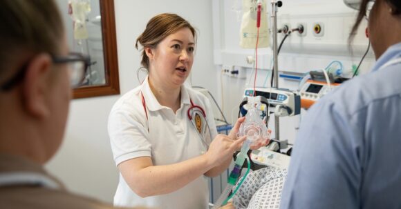 Physiotherapist talking to clinical staff during SIM training