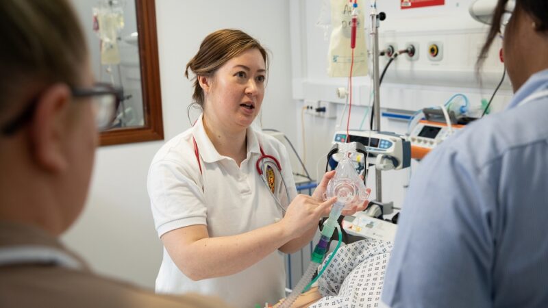 Physiotherapist talking to clinical staff during SIM training